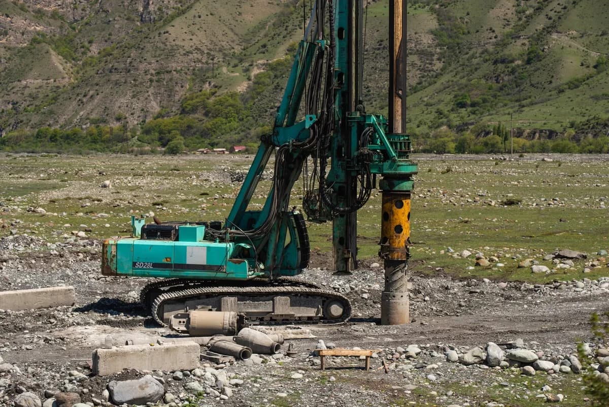 A heavy drilling rig operating on a construction site.